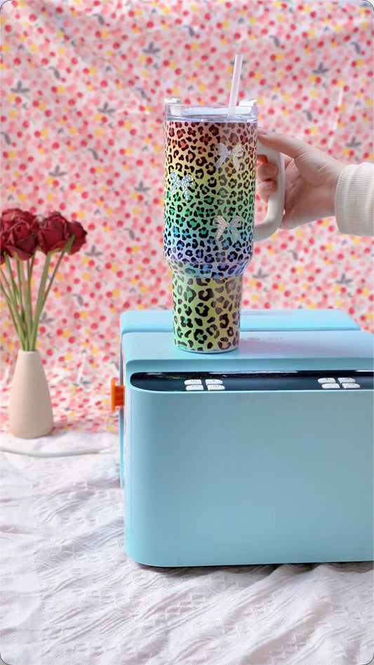 a Colorful Leopard-Print Handled Tumbler and blue A200 auto tumbler heat press