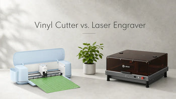 Vinyl cutter and laser engraver side by side on a concrete surface with a plant