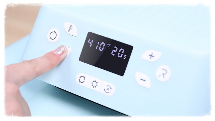 A close-up shot of the control panel of an HTVRONT auto heat press machine, showing the digital display with the temperature and time settings.