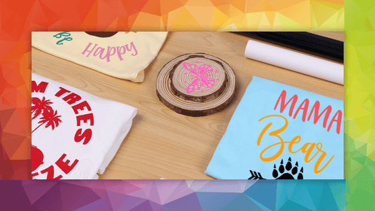 Three t-shirts with printed designs: one with palm trees, one with 'Happy Mama Bear', and one with a pink design on a wood slice.