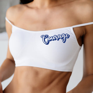 White sports bra with 'Courage' text on a blurred background