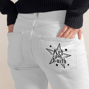 Light gray jeans with a star-shaped pocket design featuring 'Art and Faith' text on a beige background.