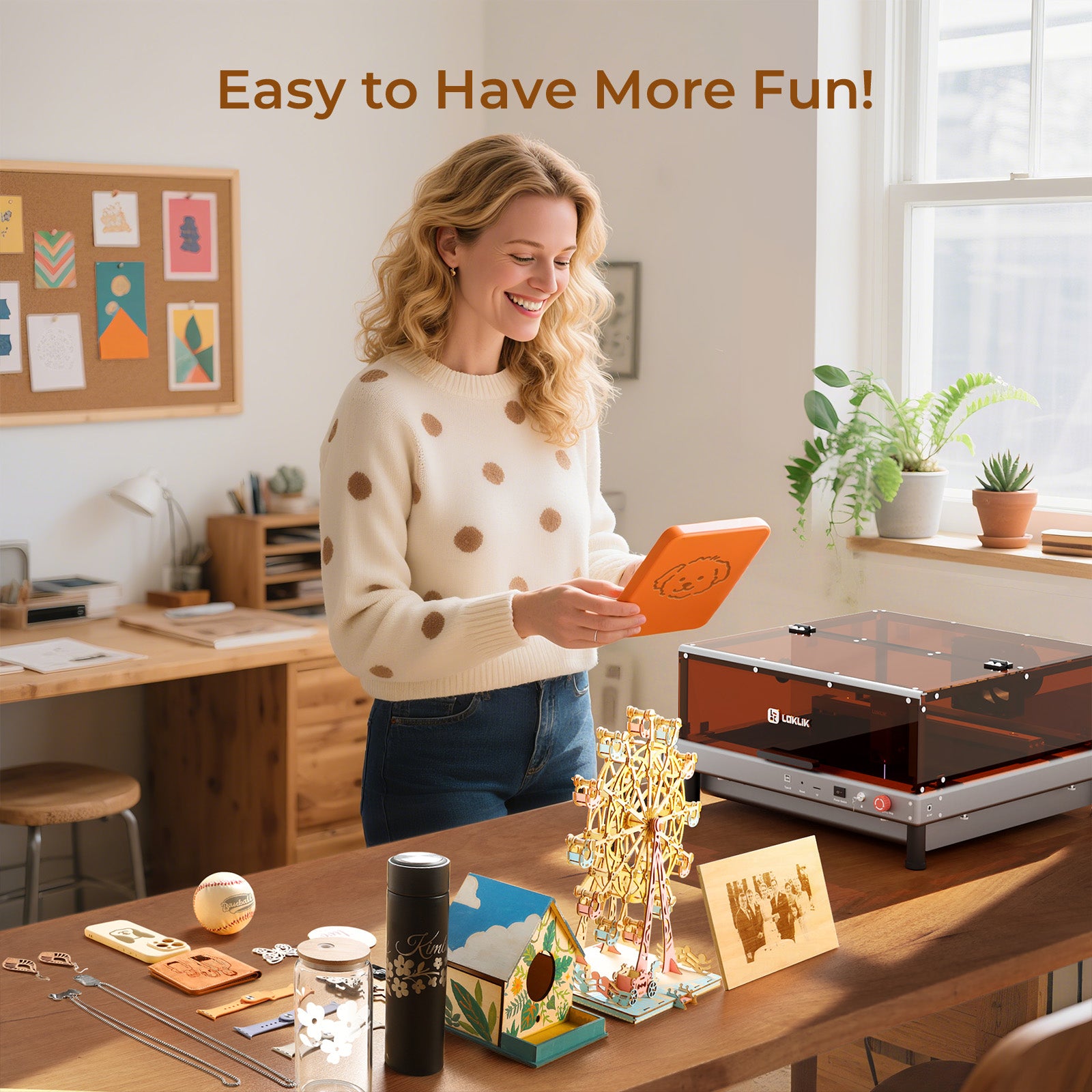 Woman using a tablet in a home office setting with a laser engraving machine on the desk.