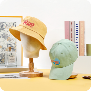 A uniquely designed fisherman's hat hangs on the mannequin's head.