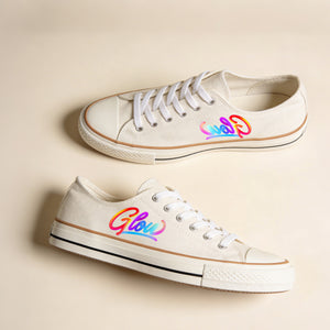 White sneakers with colorful 'Glow' design on a beige background